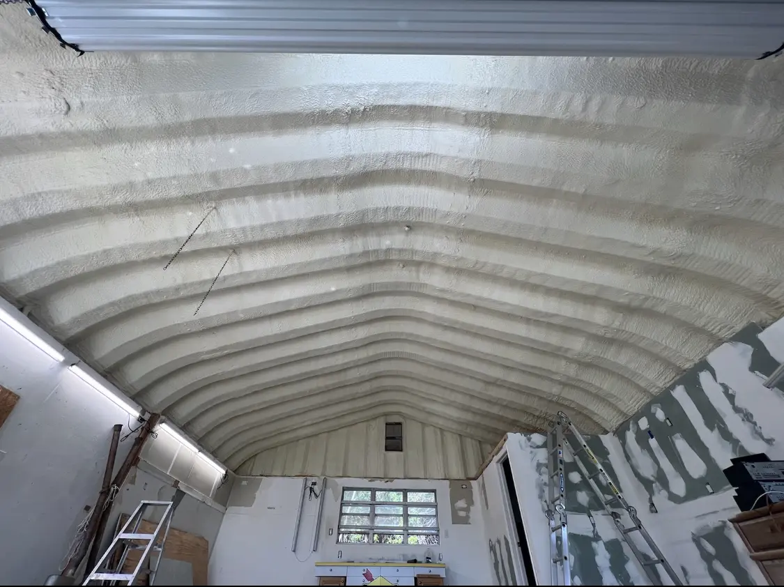 Spray polyurethane foam applied to the underside of a metal roof deck in Dickinson